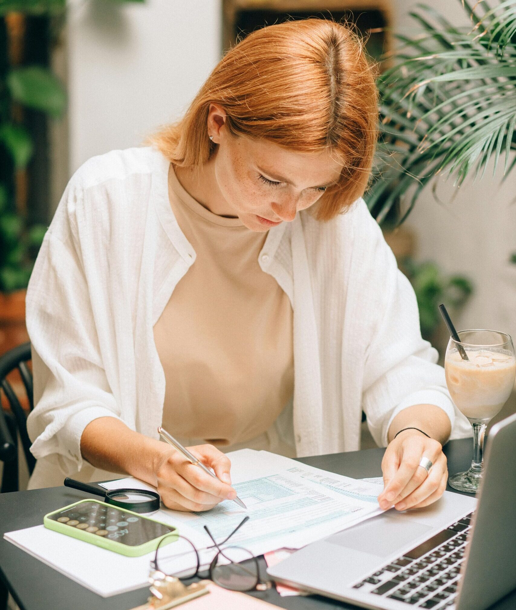 a woman writing locksmith charge on a piece of paper